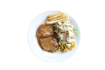 plate of grilled pork with french fries and salad