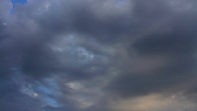 Rain clouds running across dark blue sky. 15 Second, 30 fps footage of HD timelapse cloudscape. Timelapse of clouds with blue sky in background