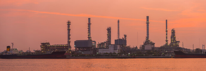 Fototapeta premium Refinery tower in petrochemical industrial plant with river