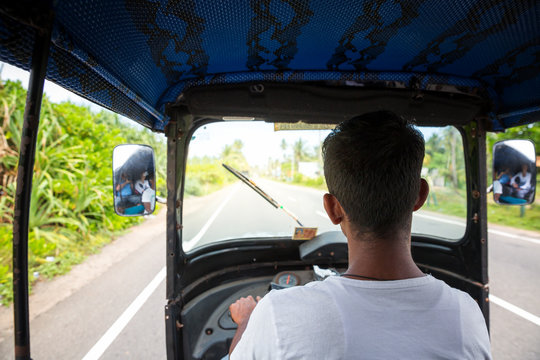 Tuk Tuk Driver On Road Of Sri Lanka, View From Car