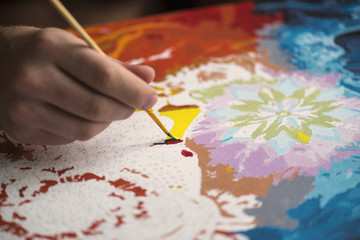 Male Artist Working On Painting on the table