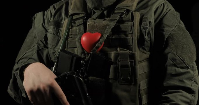 Red heart on the soldier's chest, concept