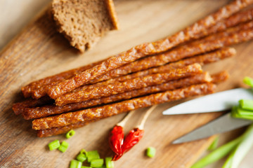 Fresh kabanos sausages, scissors, bread, pepper and onion 