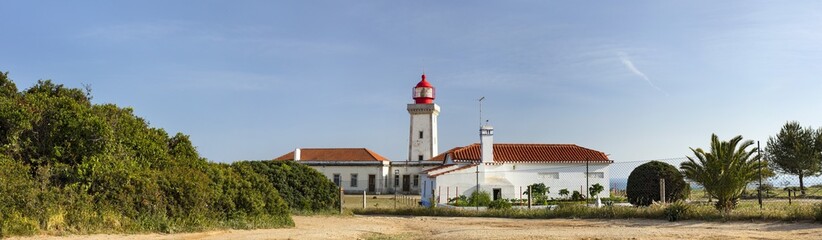 panorama with lighthouse unde blue sky