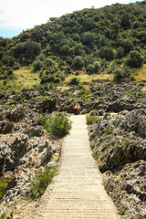Path in the rocks with danger sign in the end