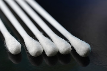 Close-up cotton buds on black background.