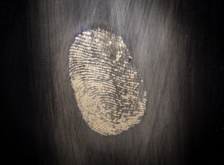 The fingerprint isolated on the glass in the dark