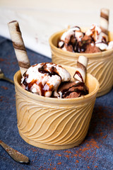 Delicious ice cream in a cup with chocolate sauce cream rolls