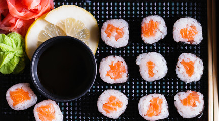 Sushi rolls with salmon, soy sauce and chopsticks 