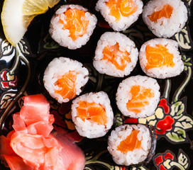 Sushi rolls with salmon, ginger and lemon slice 