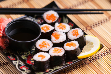 Sushi rolls with salmon, soy sauce and chopsticks 