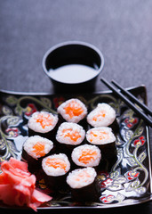 Sushi rolls with salmon, soy sauce and chopsticks 
