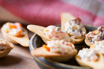 Tartlets with spicy salad on a wooden background 