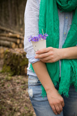 Obraz na płótnie Canvas Woman holding beautiful snowdrop. first spring flowers in a forest. Wild flowers. spring concept.