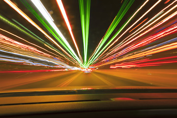 Long exposure speed car lights trails on a night highway.