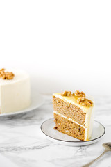 piece of wedding or Birthday sugar free and gluten free Cake with salty caramel and nuts on marble background. Vegan food concept