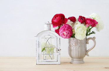 Bouquet of pink and white rosses in the vintage white vase
