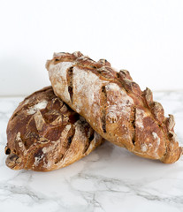 Fresh home made bread with nuts and dry fruits on marble background