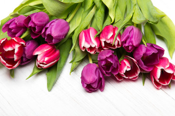 Tulip bouquet on white wooden background, copy space