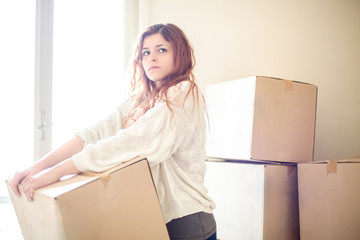 Serious Redhead Woman House Moving with Boxes