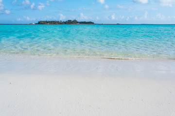 Tropical sand beach and blue sky with white clouds