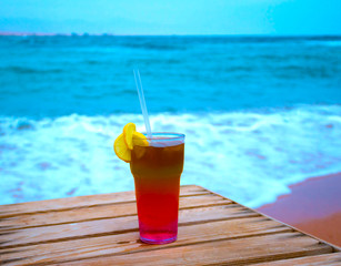 The cocktail with blur beach on background
