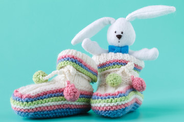 Knitted baby booties with toy