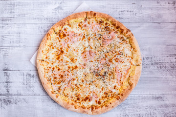 Pizza on a wooden white table