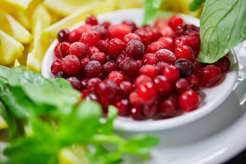 Cranberries on plate and lemons