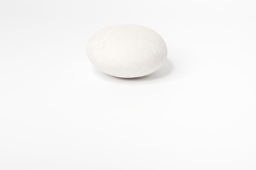 Fototapeta na wymiar White stone of a round form are isolated on a white background