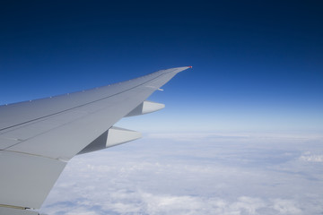Fototapeta na wymiar Beautiful blue sky background with wing aircraft