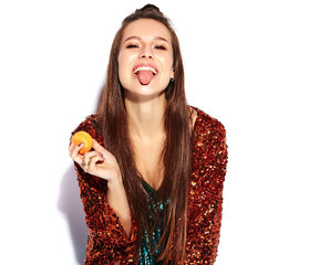 Beautiful caucasian smiling hipster brunette woman model in bright shinny reflecting summer stylish jacket and green dress isolated on white background. Eating french macaroon and showing her tongue