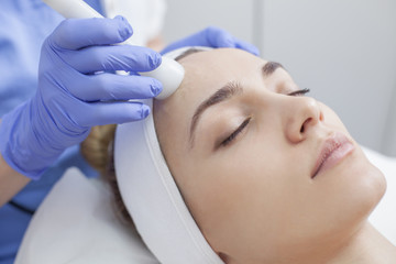 Obraz na płótnie Canvas Face skin care. Woman getting facial laser treatment