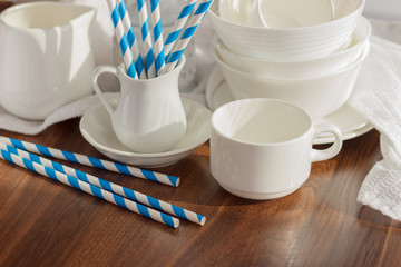 Set of white empty tableware with striped tubules