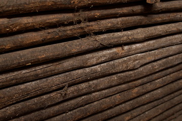 closeup old wooden fence of logs in form of palisade focus