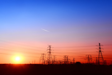 Fototapeta premium High voltage towers, under the setting sun