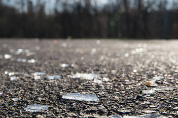 Broken glass pieces on the ground