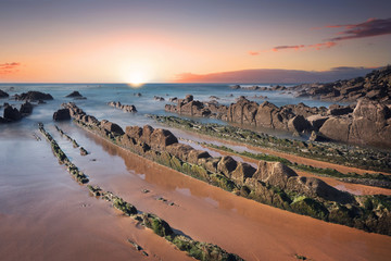 Scenic Sunset at barrika beach, mossy rocks. Bilbao, Basque country, Spain.