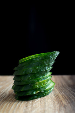 green cucumber on wooden surface