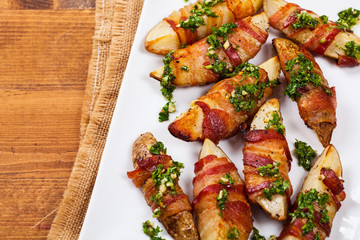 Bacon Wrapped Potatoes with Parsley Garlic Pesto Sauce. Selective focus.