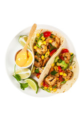 Shrimp Tacos with Corn and Avocado Salsa Isolated on White background. Selective focus.