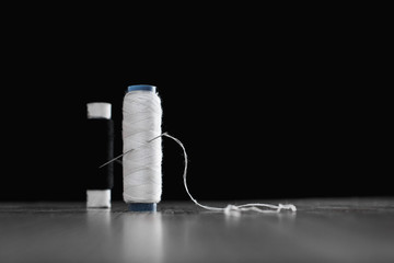 two coils with white and black threads