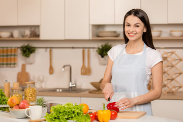 Obraz na płótnie Canvas Young Woman Cooking in the kitchen. Healthy Food. Dieting Concept. Healthy Lifestyle. Cooking At Home. Prepare Food