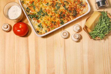 Chiken vegetable cheese pie on the light wooden background