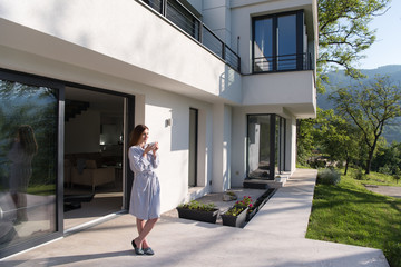 woman in a bathrobe enjoying morning coffee