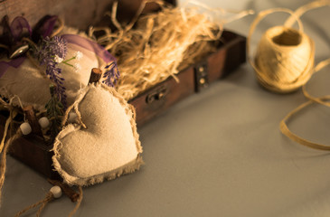 Textil heart next to a wooden gift box