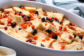 Freshly baked bread pudding in casserole dish, closeup