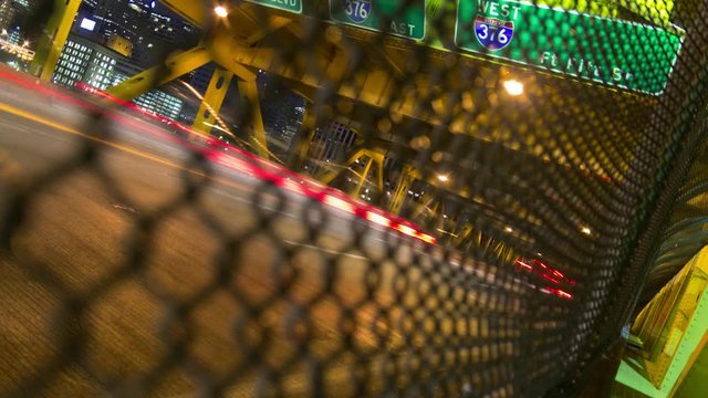 4K Night Timelapse Of Cars Streaking Down City Highway Bridge