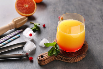 Delicious tequila sunrise cocktail on cutting board
