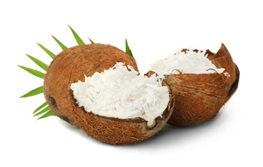 Grated coconut in shell and whole nut on white background